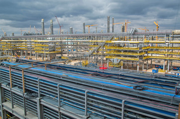 Type of metal structures of a large plant, overpasses, communications, cranes, pipes. Large-scale view from a height.
