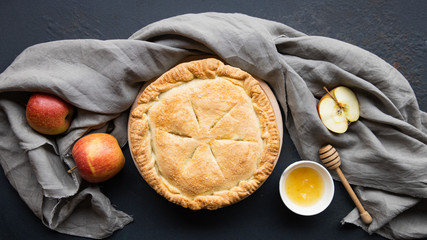 Apple pie on a wooden background, selective focus. Homemade American Pie from Organic Autumn Apples.