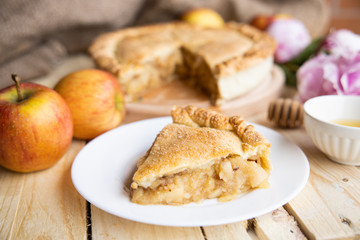 Apple pie on a wooden background, selective focus. Homemade American Pie from Organic Autumn Apples.