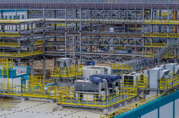 Type of metal structures of a large plant, overpasses, communications, cranes, pipes. Large-scale view from a height.
