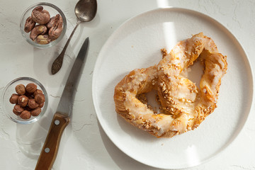 sweet pretzel with icing and nuts, sweet pastries