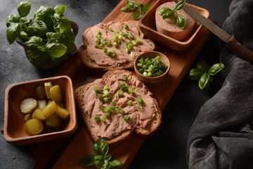 Chicken or goose liver pate sandwiches on a wooden board