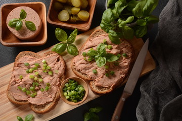Chicken or goose liver pate sandwiches on a wooden board