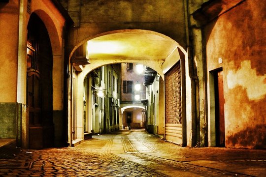 Illuminated Walkway Amidst Houses At Night