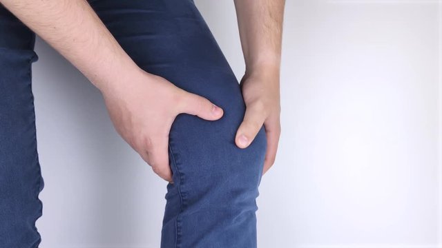 A man suffers from knee pain. Examination by an orthopedist and traumatologist. Redness and swelling of the legs, torn meniscus or knee bursitis