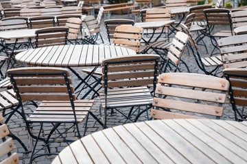 Empty street cafe, wooden tables and chairs