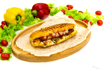 Hot dog, meat kebab on a plate with vegetables, traditional meat food in pita bread