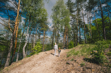 Mother and daughter in forest walking and having fun