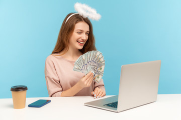 Look at money profit! Lovely angelic rich woman with nimbus holding dollar banknotes while talking...