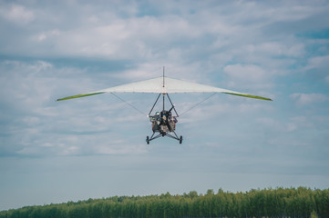 Fototapeta na wymiar The motorized hang glider ready to landing