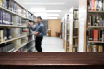 Empty wooden desk space platform with library background for product display montage. Education concept.