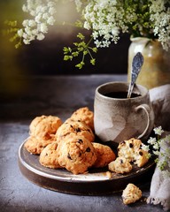 Homemade cookies with oatmeal and chocolate drops on a plate with a mug of coffee. Breakfast. Still...