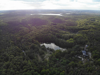 Fototapeta premium Aerial view of lake Teufelssee a glacial lake in the Grunewald forest in the Berlin borough of Charlottenburg-Wilmersdorf.