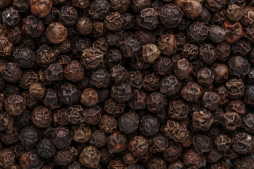 Peppercorn background. Dry black pepper seeds. Top view. Flat design. Macro spice background