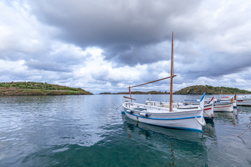 Fototapeta na wymiar Beautiful seascape with fishing boats under dramatic sky.