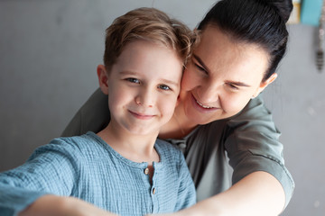 Mom and kid are laughing together in cozy home