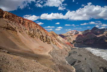 Fototapeta premium Beautiful landscape of mountain peaks. Hilly area. Mountainious terrain. Red sand.