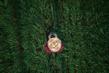 Aerial view of barley farmer using drone remote controller