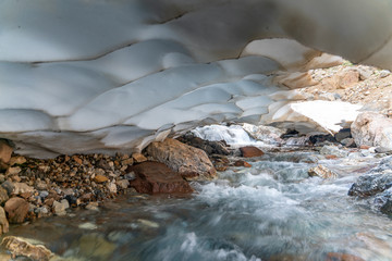 The beautiful view of frozen glacier and Kaznok river neat to Zmeya peak in Fann mountains in Tajikistan