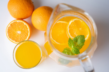 A pitcher of summer healthy lemonade, a cocktail of orange, mint and ice
