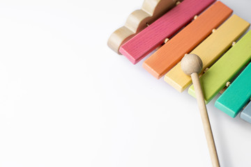 children's musical multi-colored wooden instrument xylophone on a white background