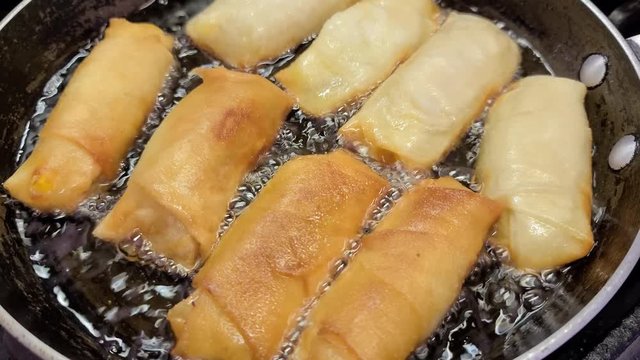 Cooking banana spring rolls or filipino turon. Typical Filipino meryenda and dessert