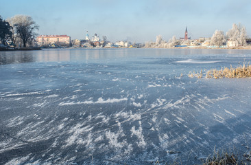 frozen river with beautiful ice and the city in the background