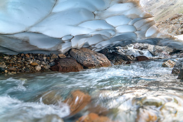 The beautiful view of frozen glacier and Kaznok river neat to Zmeya peak in Fann mountains in Tajikistan