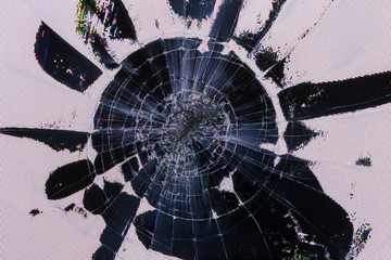 Impact damage on lcd screen, radial cracks, pixel grid leakage and discoloration. Close-up with...