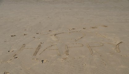 Be happy my love written on the sand