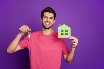 Photo of attractive handsome guy good mood raise green paper house building key chain real estate...