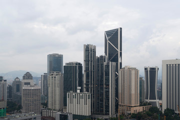 Fototapeta premium Panoramic view of Kuala Lumpur skyline at day time. City center of capital of Malaysia. Contemporary buildings exterior with glass.