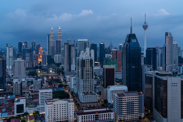 Fototapeta premium Panoramic view of Kuala Lumpur skyline at night time. City center of capital of Malaysia. Illumination lights contemporary buildings exterior with glass.