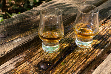 Tasting of different Scotch whiskies on outdoor terrace, dram of whiskey