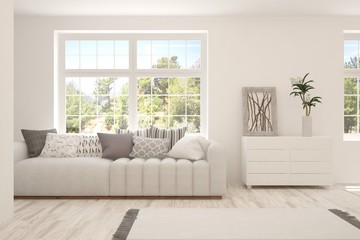 White living room with sofa and summer landscape in window. Scandinavian interior design. 3D illustration