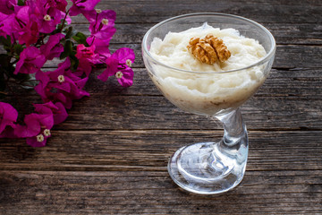 Turkish desert güllaç on the wooden rustic table.