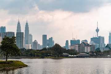 Fototapeta na wymiar Panoramic view of Kuala Lumpur skyline at sunset. City center of capital of Malaysia. Contemporary buildings exterior with glass.