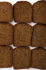 Vertical image.Lot of sliced rye bread as a background