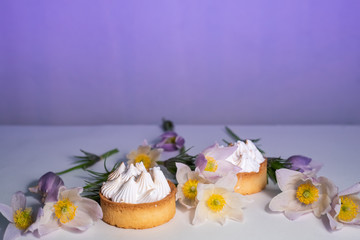Delicate white flowers and pastries with white cream