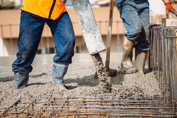 construction site details - building concrete slabs at house construction and pouring cement on...