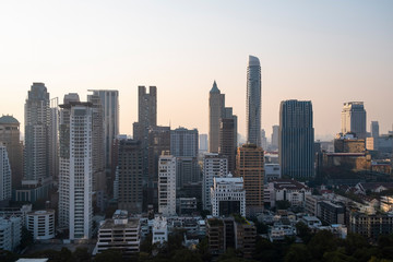 Fototapeta na wymiar Panoramic view of Bangkok skyline at sunset. Modern city center of capital of Thailand. Contemporary buildings exterior with glass.