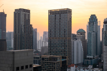 Fototapeta premium Panoramic view of Bangkok skyline at sunset. Modern city center of capital of Thailand. Contemporary buildings exterior with glass.