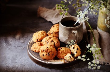 Homemade cookies with oatmeal and chocolate drops on a plate with a mug of coffee. Breakfast. Still life