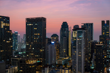 Fototapeta na wymiar Panoramic view of Bangkok skyline at sunset. Modern city center of capital of Thailand. Contemporary buildings exterior with glass.