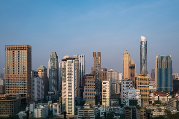 Obraz na płótnie Canvas Panoramic view of Bangkok skyline at sunset. Modern city center of capital of Thailand. Contemporary buildings exterior with glass.