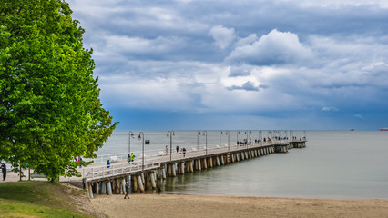 Pier in Gdynia Orlowo, Poland. Beautiful nature, Baltic Sea and tourists..
