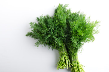 Top view of two bunches of dill on the white background.Empty spac