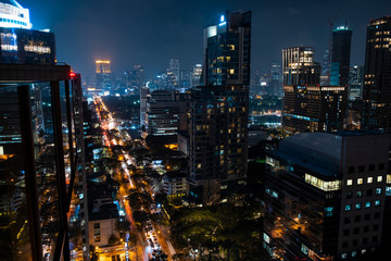 Fototapeta na wymiar Panoramic view of Bangkok skyline at night time. Illuminated city center of capital of Thailand. Contemporary buildings exterior with glass.