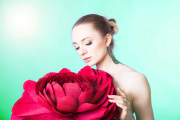 Fototapeta premium beautiful young model with tattoos and soft skin after Spa treatments and cosmetics with a red rose