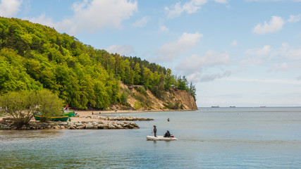 View of the cliff in Gdynia Orlowo with fisherman in May.